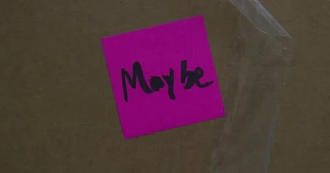 MAYBE - Post It Note - Put on Box - Text of the word "MAYBE" - 4k Stock Footage 66768432