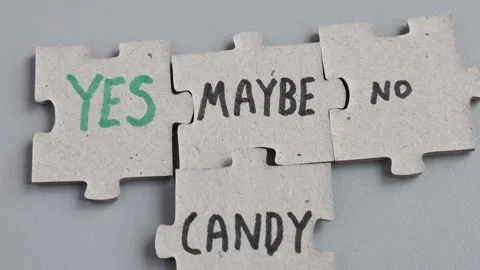 Maybe YES candy concept. Puzzle piece concept. Gray background. Stock Footage 304631282