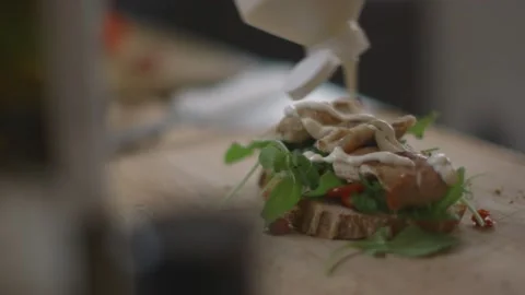 Mayo and slice of bread being put onto sandwich base Stock Footage 194478402