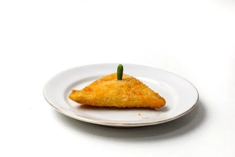 Mayo rissoles are triangular in shape, on a white plate, with chili on top 스톡 사진