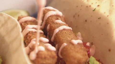 Mayonnaise and ketchup dressing on a fish finger wrap. Stock-Footage 137954553