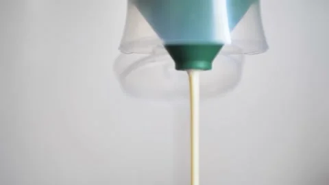 Mayonnaise being squeezed out of bottle. Stock footage. Close-up of jet of Stock Footage 223575877