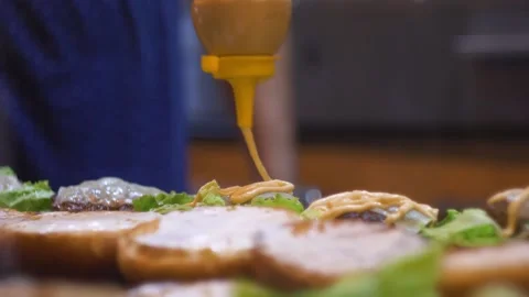 Mayonnaise on delicious cheese burger close up Stock Footage