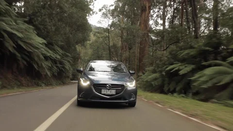 Mazda 2 Driving Through Scenic Forest Stock Footage 126567196