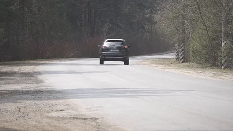 Mazda cx-9 car driving in the woods in eary spring Stock Footage 88595353
