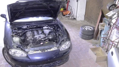 Mazda mx5 miata front view zooming engine bay Stock Footage 84296886