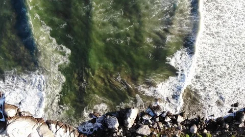 MB11_Rocky shore top view moving right following waves crashing onto the rocks. Stock Footage