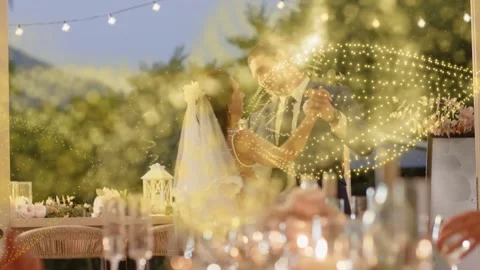 MC calling first dance, bride, groom twirling and dipping at dusk reception with Stockbeeldmateriaal 332900061