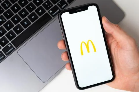 McDonalds the application is open in the smartphone. The man is holding a mobile Foto stock