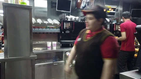 McDonald's restaurant staff at work in the kitchen. Fast food restaurant, Moscow Stock Footage 128629897