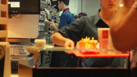 McDonald's worker serving customer Stock Footage 99727279
