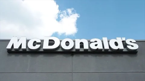 Mcdonalds writing caption text sign logo in white on gray restaurant building Video stock 250280532