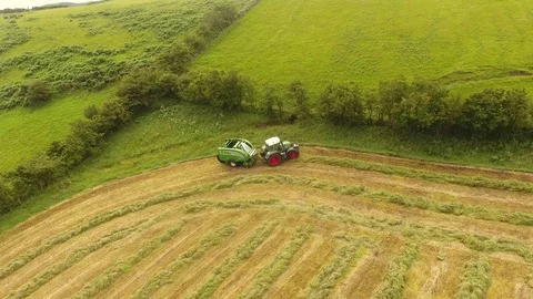 McHale round bale wrapper Fendt 718 tractor baling grass for silage 4 4K Stock Footage 127872879