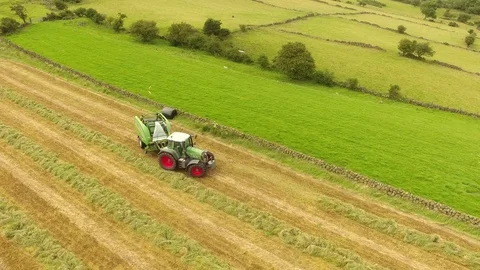 McHale round bale wrapper Fendt 718 tractor baling grass for silage 8 4K Stock Footage 127873530