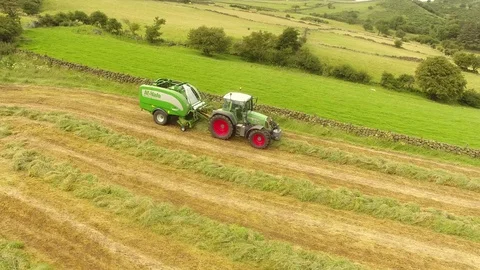 McHale round bale wrapper Fendt 718 tractor baling grass for silage 6 4K Stock Footage 127873763