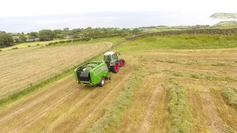 McHale round bale wrapper Fendt 718 tractor baling grass for silage 10 4K Stock Footage 127874782