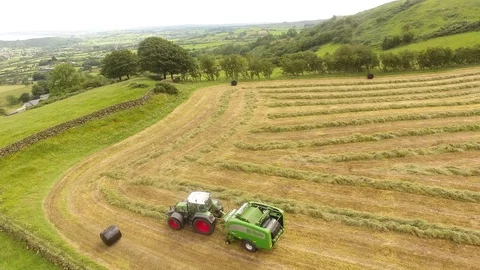 McHale round bale wrapper Fendt 718 tractor baling grass for silage 9 4K Stock Footage 127874952
