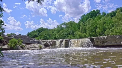 Mckinney Falls show at low angle with bubbly stream in foreground 스톡 동영상 142399106