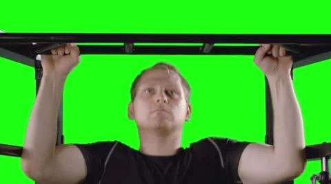 MCU Man Doing Pull Ups on Exercise Frame with Green Background 4K Stock Footage 57984563