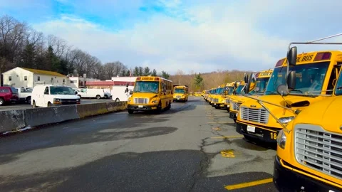 MD, USA 12-21-2020: school buses are leaving the county depot Stock Footage 145500742