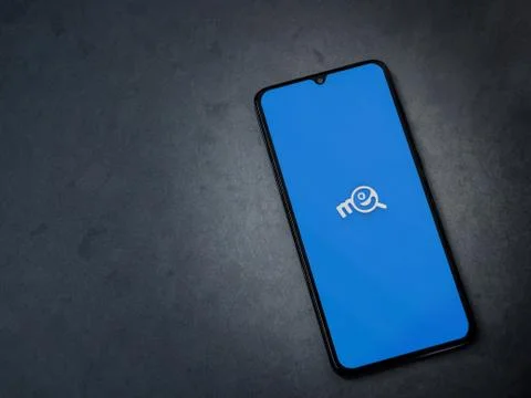 Me app launch screen with logo on the display of a black mobile smartphone on Stock Photos