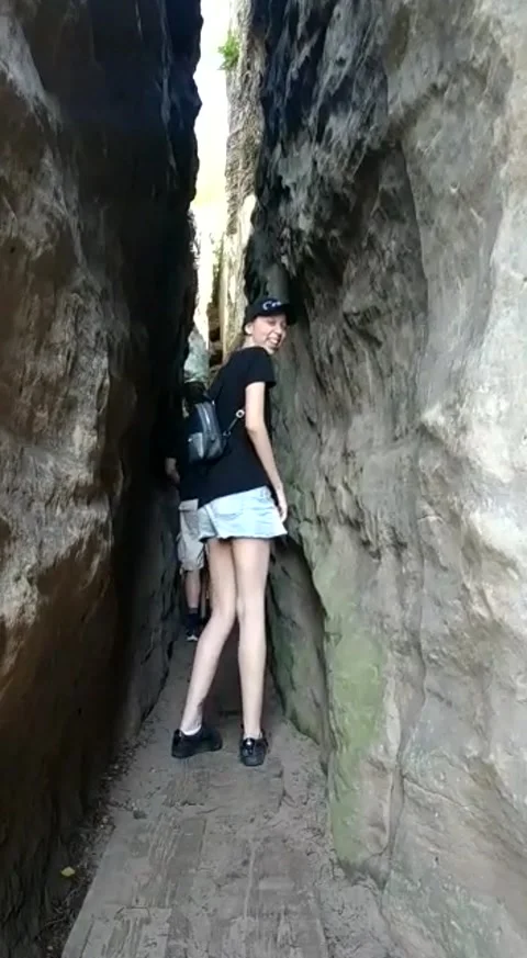 Me walking through narrow space, in the rocks Stock Footage 161785758