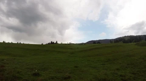 Meadow in the Mountainous Area Covered With Grass Over Which Hovering Some Stock Footage 63969108