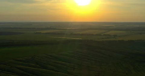 Meadows and agricultural fields at sunset from above, beautiful landscape Vídeo Stock 132825810