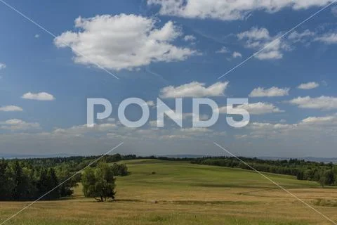 Meadows and pasture land near vanished village Smrkovec in summer hot day Stock Photos