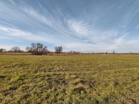 Meadows and the sky with clouds Stock Photos