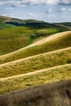 Meadows in the mountains create sinuous lines. Stock Photos