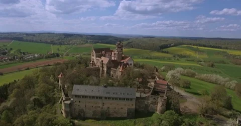 Meadows in spring in front of castle Ronneburg Stock Footage