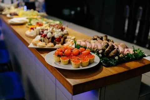 Meal. Festive buffet table for guests. Assortment of cold cuts,canapes on wooden Stock Photos