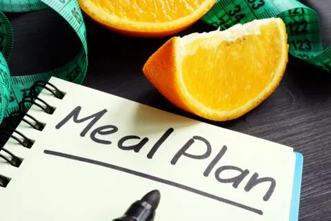 Meal plan concept. Note pad and measuring tape. Stock Photos