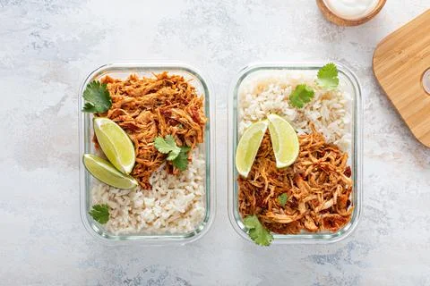 Meal prep containers with pulled chicken with salsa and rice Stock Photos