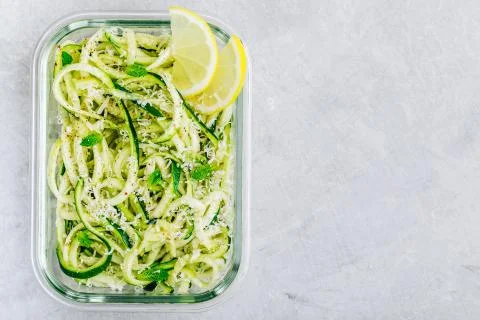 Meal prep lunch box containers Spiralized zucchini noodles pasta with mint, l Stock Photos