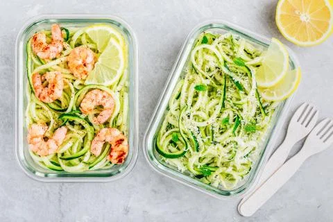 Meal prep lunch box containers Spiralized zucchini noodles pasta with shrimps Stock Photos