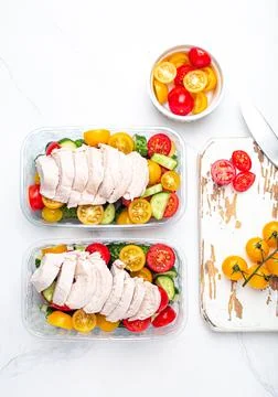 Meal prep lunch boxes containers with chicken and salad top view Stock Photos