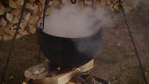 Meal is prepared in a cast-iron pot on the fire Stock Footage 113523457