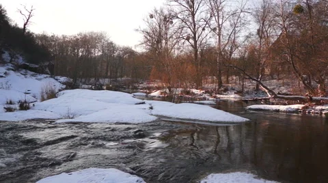 Meandering river flowing between the snow-covered banks 動画素材 44665516