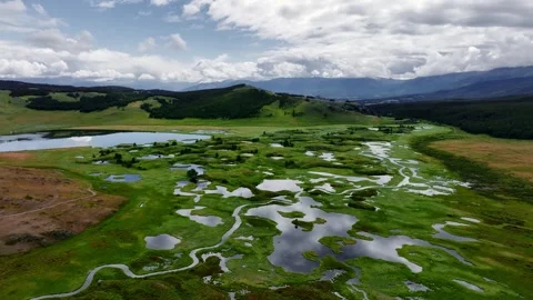 Meanders. Multiple spills of a mountain river stream in a steppe mountainous Stock Footage 332659105