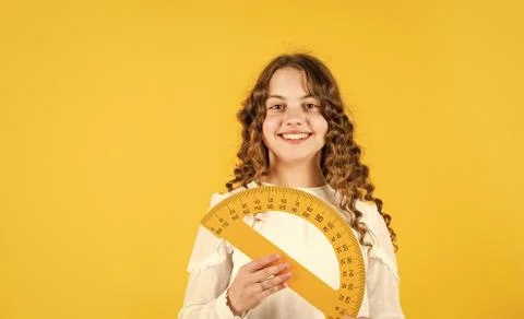 Measure angles in degrees. School lessons. Adorable cute pupil. She loves Foto stock