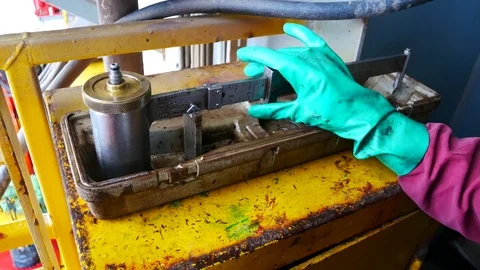 Measure mud density by using a pressurized mud balance Stock Footage 84530817