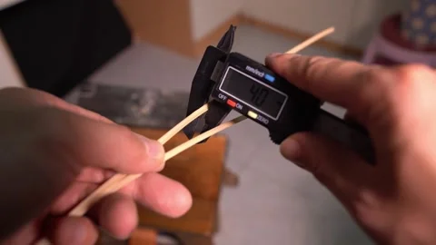 Measure the width of bamboo strips using an electronic vernier caliper Stock Footage 278301814