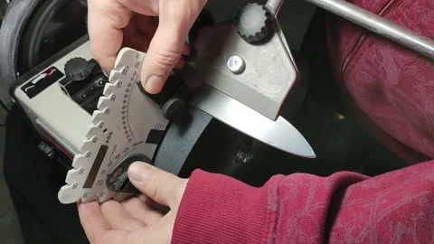 Measurement and setting of the knife sharpening angle before processing it on a Stock Footage 144970862