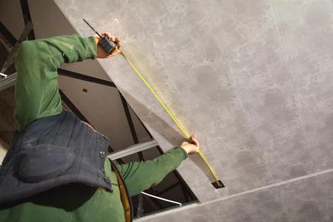 Measurement of ceiling connected to plastic frame. Stock Photos