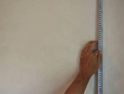 Measurement on the surface of an empty wall Stock Photos