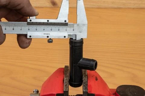 Measurement of tee diameter using calipers Stock Photos