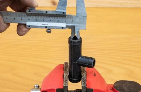 Measurement of tee diameter using calipers Stock Photos
