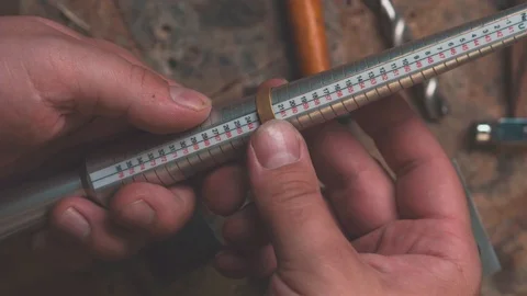 Measures a golden ring on a sizer gauge Stock Footage 112270994